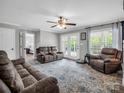 Bright living room with hardwood floors, a ceiling fan, and French doors leading to the patio at 208 Wellington Dr, Lincolnton, NC 28092