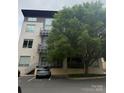 Apartment building with modern architecture, balconies, and a parking area at 2116 Mcclintock Rd # 123, Charlotte, NC 28205