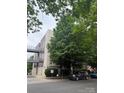 A contemporary building with a connecting walkway, lush trees, and ample parking at 2116 Mcclintock Rd # 123, Charlotte, NC 28205