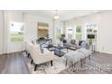 Bright living room showcasing large windows, hardwood floors, and stylish decor at 215 Tillery Ln # 756P, Mount Gilead, NC 27306