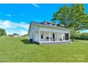 Lovely white farmhouse with a inviting porch, set on a sprawling green lawn at 221 Abner Rd, Stony Point, NC 28678