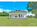 Quaint white home featuring a cozy front porch for a welcoming curb appeal at 221 Abner Rd, Stony Point, NC 28678
