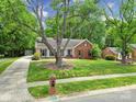 Beautiful home showcasing its spacious front yard, complemented by mature trees and landscaping at 2626 Lilly Mill Rd, Charlotte, NC 28210