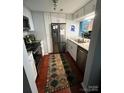 Updated kitchen featuring stainless steel appliances and tile backsplash at 300 S Cedar St # 2, Charlotte, NC 28202