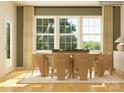 Bright dining room with large windows, wood floors, modern furniture, and neutral decor at 3915 Horsham St, Indian Land, SC 29707