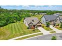 Stunning aerial shot of a home with a well-manicured lawn and lush green neighborhood, in a friendly community at 475 Hunton Forest Nw Dr, Concord, NC 28027