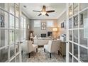 Bright office space with glass French doors, neutral walls, and stylish furnishings, ideal for remote work at 475 Hunton Forest Nw Dr, Concord, NC 28027