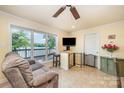 Cozy living room with tile floors, a comfortable couch, and a sliding glass door leading to the outdoor deck at 4960 Longfield St, Claremont, NC 28610