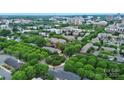 Charming aerial view of property situated among mature trees with manicured circle at 526 N Davidson St, Charlotte, NC 28202