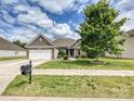 Beautiful single-story home with brick accents, attached garage, and a lush green lawn at 5355 Hackberry Sw Ln, Concord, NC 28027