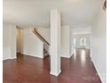 Spacious open-concept living area with hardwood floors and a staircase at 5355 Hackberry Sw Ln, Concord, NC 28027
