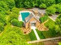 Aerial view of a community pool, surrounded by lush greenery, parking, and ample seating at 720 Kingsmill Ln, Clover, SC 29710