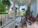 Cozy front porch featuring rocking chairs, a patterned rug, and views of the neighborhood at 757 Shady Grove Xing, Fort Mill, SC 29708