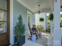 Comfortable covered front porch with rocking chairs and decorative potted plants at 757 Shady Grove Xing, Fort Mill, SC 29708