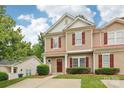 Charming two-story townhouse with tan siding, red shutters, and a neatly landscaped front yard at 8259 Carob Tree Ln, Charlotte, NC 28215