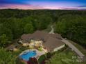 Aerial view of estate featuring a backyard pool, hot tub, mature trees, and a long driveway at 8451 Ridgewood Rd, Sherrills Ford, NC 28673