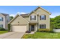 Inviting home with a two-car garage, manicured lawn, and 'Welcome' sign near the front door at 9437 Tavistock Ct, Matthews, NC 28105