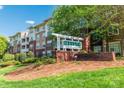 Apartment building with a 'Preston at Flats' sign, showcasing the well-kept exterior at 1000 E Woodlawn Rd # 408, Charlotte, NC 28209