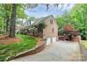 Brick home featuring an attached two-car garage and well-maintained lawn, perfect for suburban living at 10209 Thomas Payne Cir, Charlotte, NC 28277