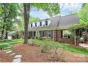 Beautiful brick home with dormer windows and lush landscaping providing excellent curb appeal at 10209 Thomas Payne Cir, Charlotte, NC 28277
