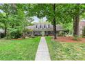 Inviting brick home showcasing meticulous landscaping and a charming front walkway at 10209 Thomas Payne Cir, Charlotte, NC 28277