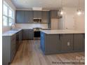New kitchen with gray cabinets, modern countertops, island and stainless steel appliances at 11453 Prosperity Church Rd, Huntersville, NC 28078