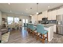 Modern kitchen featuring a spacious island with bar seating, stainless steel appliances, and stylish pendant lighting at 11741 Blessington Rd, Huntersville, NC 28078