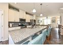 Open-concept kitchen boasts granite countertops, stainless steel appliances, and seamless flow to the living area at 11741 Blessington Rd, Huntersville, NC 28078