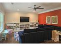 Comfortable living room with an accent wall, large sectional, built-in bookshelves, and playful, colorful decor at 1200 Kent Dr, Lancaster, SC 29720