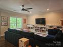 Spacious living room features a large comfortable sectional and custom built-in shelving for storage and decor at 1200 Kent Dr, Lancaster, SC 29720