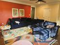 Comfortable living room featuring a large, modern sectional sofa and colorful decor on an accent wall at 1200 Kent Dr, Lancaster, SC 29720