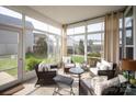 Bright sunroom with comfortable seating, perfect for enjoying the outdoors year-round at 13818 Jacks Ln, Pineville, NC 28134