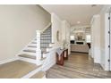 Elegant entryway featuring hardwood floors, staircase, and views to the living room at 16019 Kelby Cv, Charlotte, NC 28278