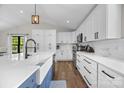 Bright kitchen featuring white cabinets, subway tile backsplash, stainless appliances, and hardwood floors at 17403 Green Hill Rd, Charlotte, NC 28278