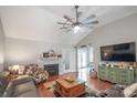 Spacious living room boasts a fireplace, hardwood floors, ceiling fan and comfortable seating at 1800 Oriole Ct, Monroe, NC 28112
