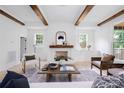 Cozy living room with exposed ceiling beams, a decorative fireplace, and stylish furnishings at 1829 Union St, Charlotte, NC 28205