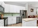 Stylish kitchen features stainless steel appliances, ample counter space, white cabinetry, and island at 2125 Southend Dr # 339, Charlotte, NC 28203
