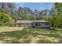 Rear exterior featuring a spacious backyard and deck, perfect for outdoor relaxation at 231 Stockwood Dr, Stanley, NC 28164