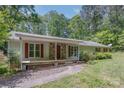 Charming ranch home featuring stone accents, red shutters and a inviting front porch at 231 Stockwood Dr, Stanley, NC 28164