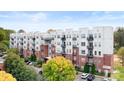 An inviting exterior view of the modern apartment building, featuring brick and metal accents at 2338 Yadkin Ave # 101, Charlotte, NC 28205