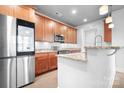 The lovely kitchen offers wood cabinets, granite counters, and stainless steel appliances at 2338 Yadkin Ave # 101, Charlotte, NC 28205