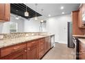 The lovely kitchen includes wood cabinets, granite counters, and stainless steel appliances at 2338 Yadkin Ave # 101, Charlotte, NC 28205