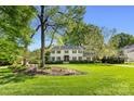 Beautiful two-story home surrounded by mature trees and lush landscaping at 2501 Richardson Dr, Charlotte, NC 28211