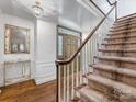 Inviting foyer with hardwood floors, staircase, and a decorative mirror at 2501 Richardson Dr, Charlotte, NC 28211