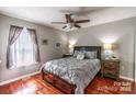 Comfortable bedroom with wood floors, a ceiling fan, and a large window at 2551 Glenwood St, Kannapolis, NC 28083
