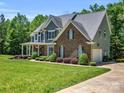 Well-manicured lawn compliments this two-story home with gray and brick exterior, and attached two car garage at 270 Conifer Way, Shelby, NC 28150