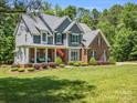 Beautiful two-story home featuring mixed brick and siding exterior, with a covered front porch, and well-kept lawn at 270 Conifer Way, Shelby, NC 28150