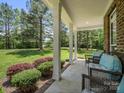 Inviting front porch with plenty of seating and beautiful views of the large front lawn and mature trees at 270 Conifer Way, Shelby, NC 28150