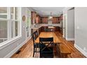 Well-appointed kitchen features dark wood cabinetry, stainless appliances, and an adjacent rustic dining table at 270 Worthington Dr, Mt Ulla, NC 28125