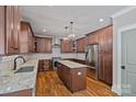 Gourmet kitchen boasts granite countertops, stainless steel appliances, and dark wood cabinets at 270 Worthington Dr, Mt Ulla, NC 28125